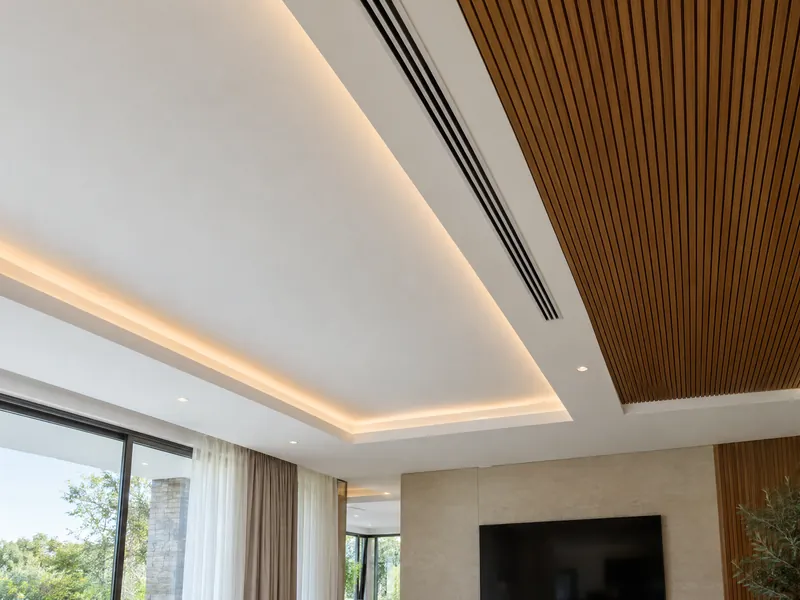 Suspended white ceiling with a lit cove and a teak slat panel